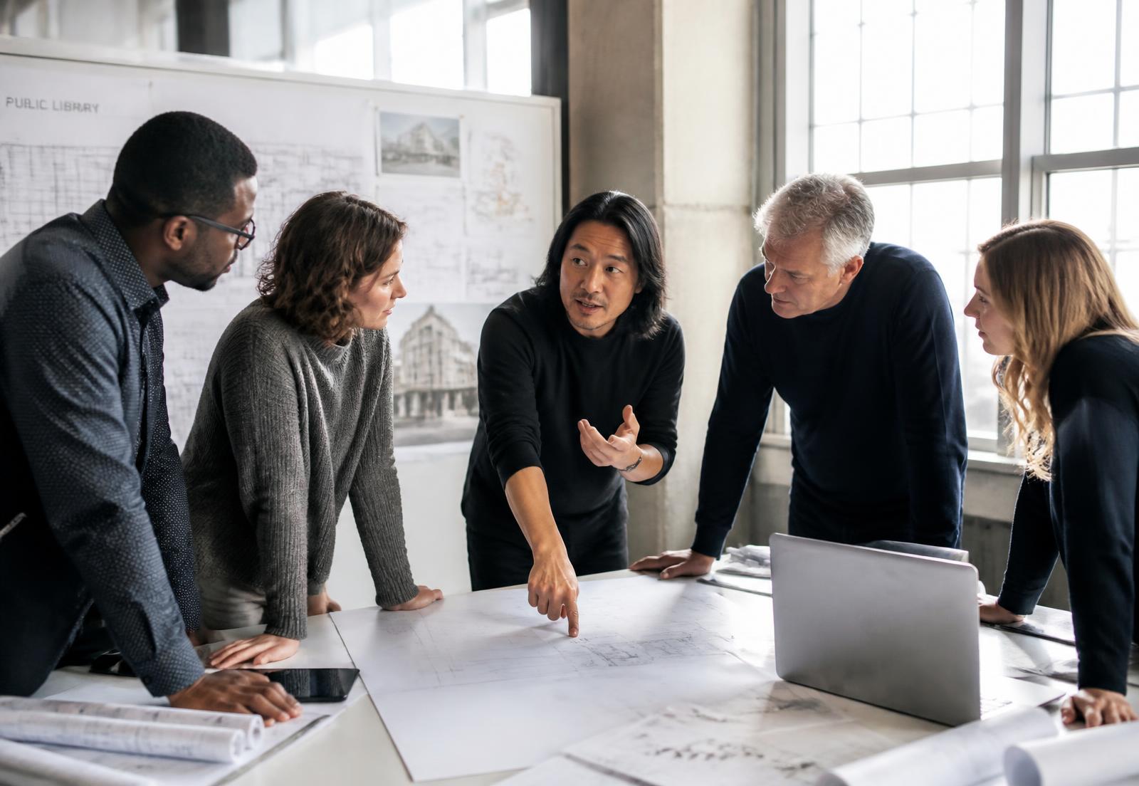 Architects and engineers reviewing drawings together in a studio